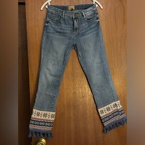 Cropped Driftwood jeans with ribbon and fringe at the hem. From Sundance.